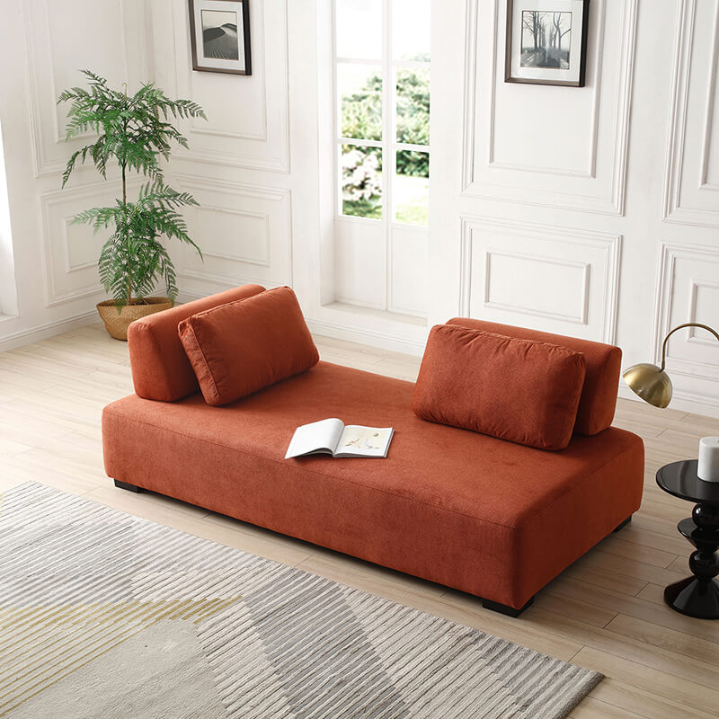 Close-up of the non-slip cushions on the orange sofa, highlighting comfort and quality craftsmanship.