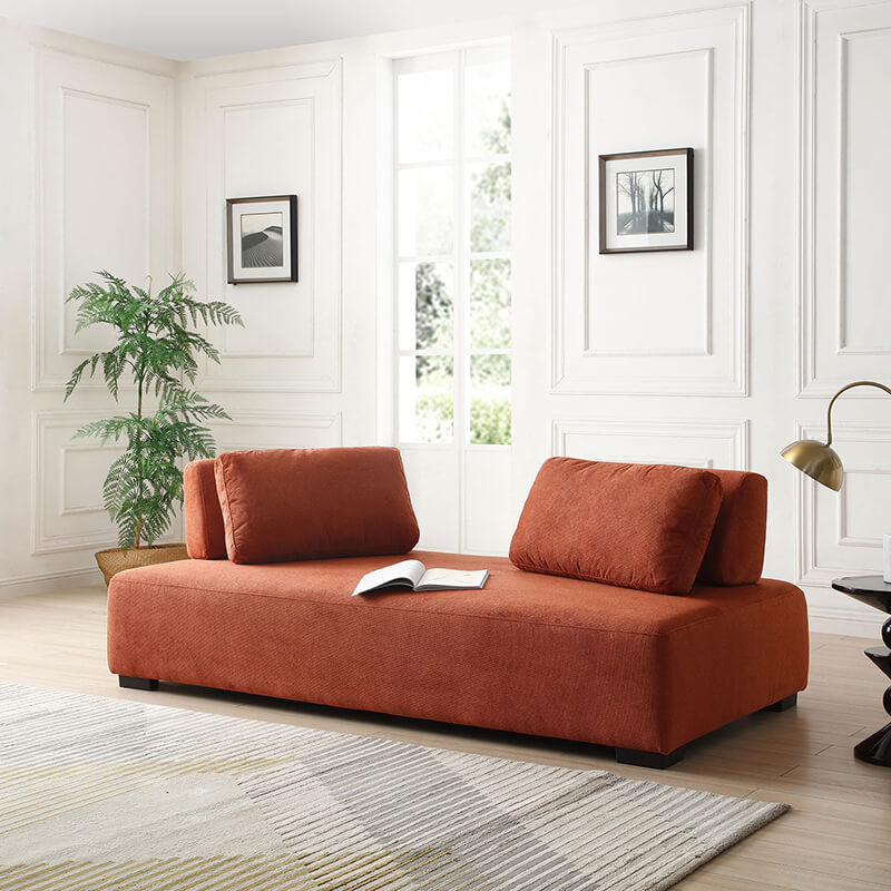 Side angle of the modular orange sofa in a stylish living room setting, demonstrating its versatility.