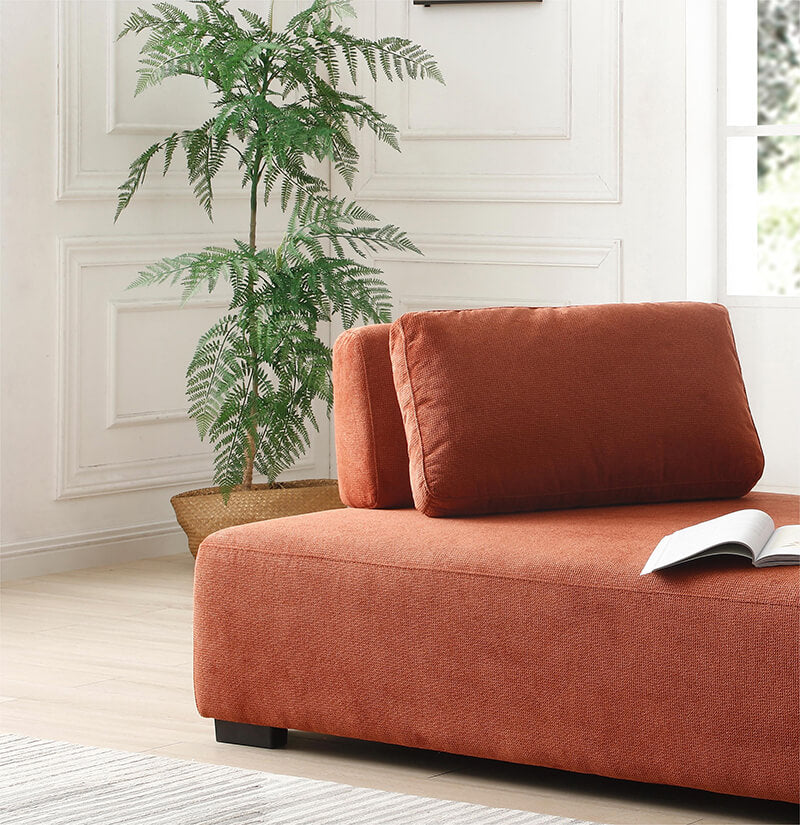 Close-up of the non-slip cushions on the orange sofa, highlighting comfort and quality craftsmanship.
