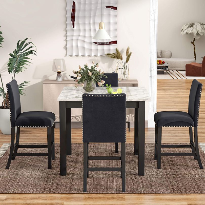 Elegant 5-piece counter height dining set with marble table and black chairs, showcasing a modern dining space.