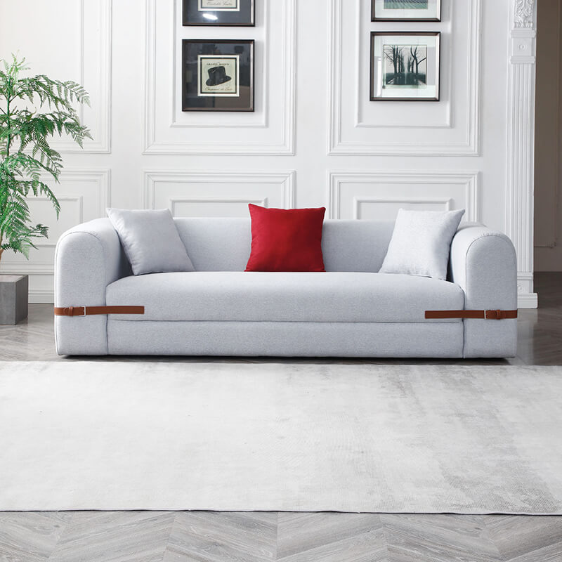 Front view of the luxurious modern gray sofa showcasing its plush design and leather accents.