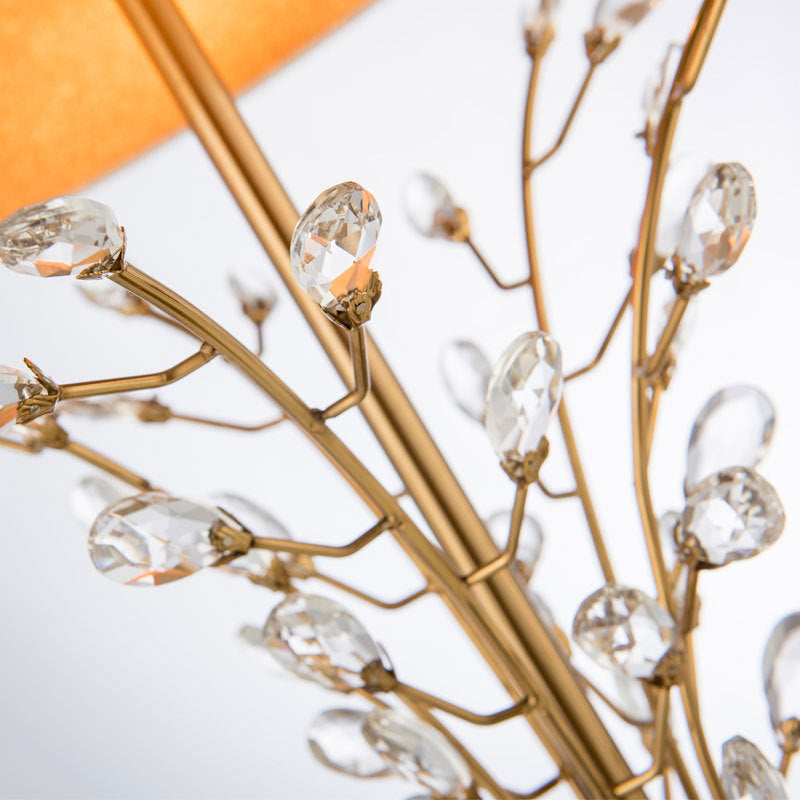 Luxury branched crystal table lamp with fabric shade in a living room setting, showcasing its modern style and elegant design.