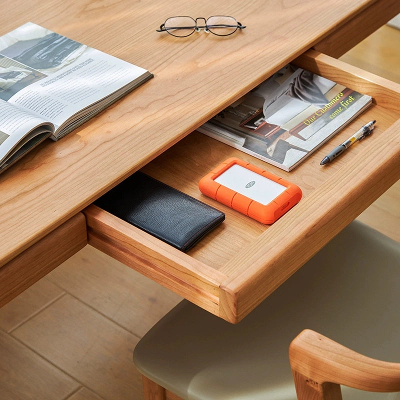 Close-up of the storage drawers on the cherry wood desk, highlighting functionality.