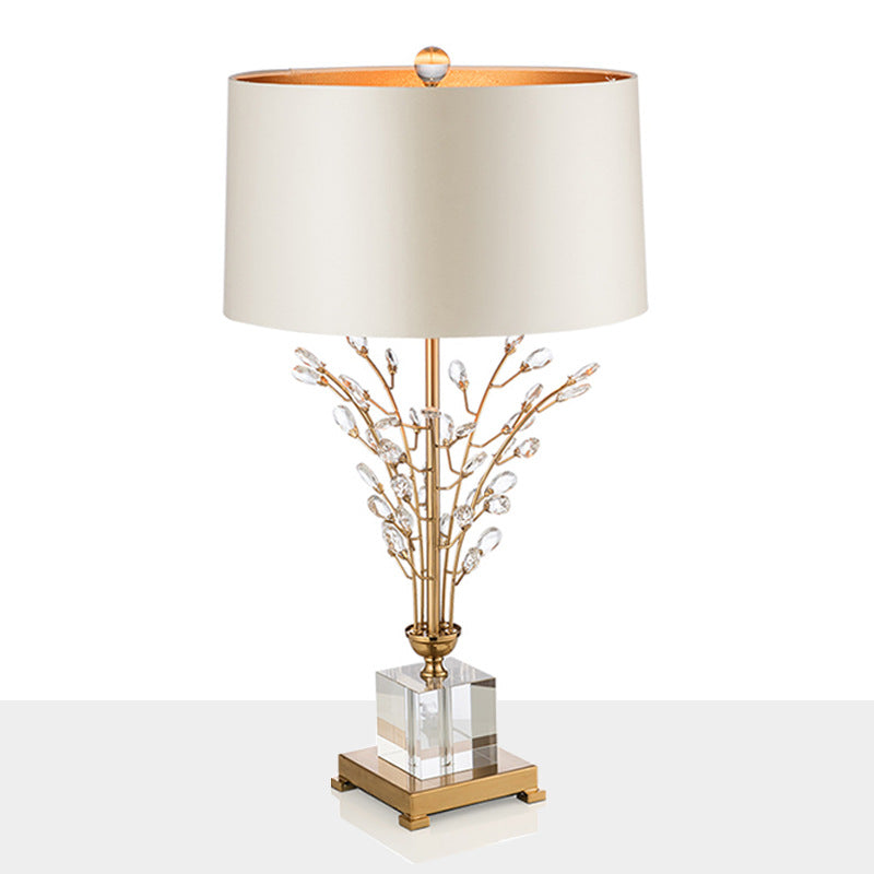 Luxury branched crystal table lamp with fabric shade in a living room setting, showcasing its modern style and elegant design.