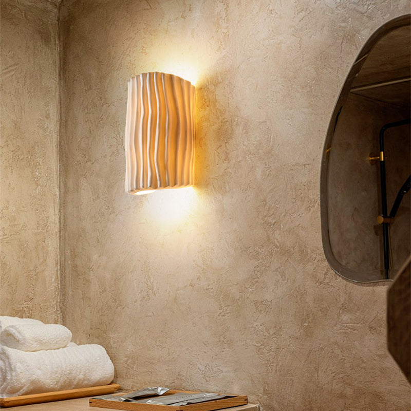 The modern wall light installed in a cozy living room setting