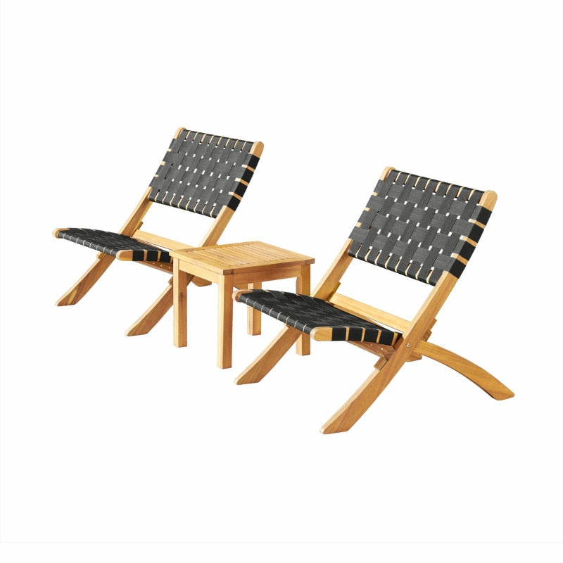 Foldable chairs and elegant coffee table arranged in a cozy garden corner.