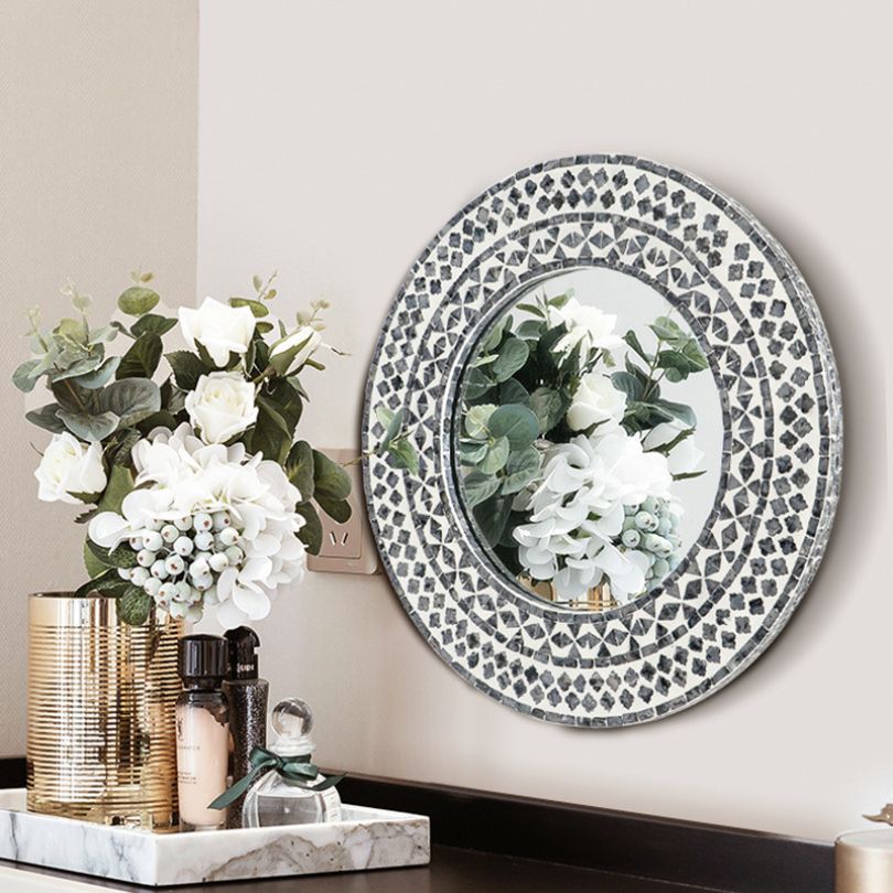 Geometric vintage resin wall mirror showcasing its elegant round shape and silver color.