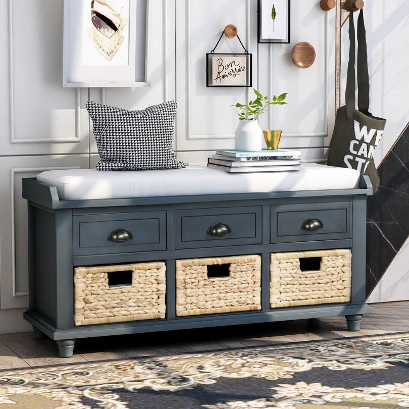 Side view of vintage blue storage bench with three drawers and removable cushion