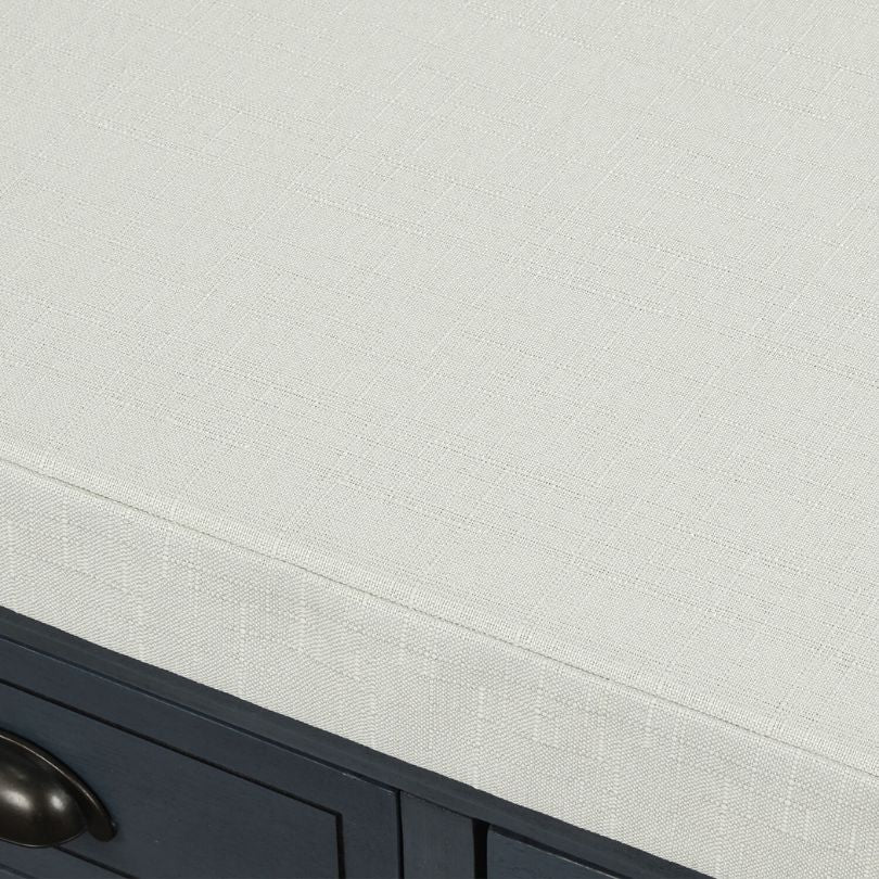Side view of vintage blue storage bench with three drawers and removable cushion