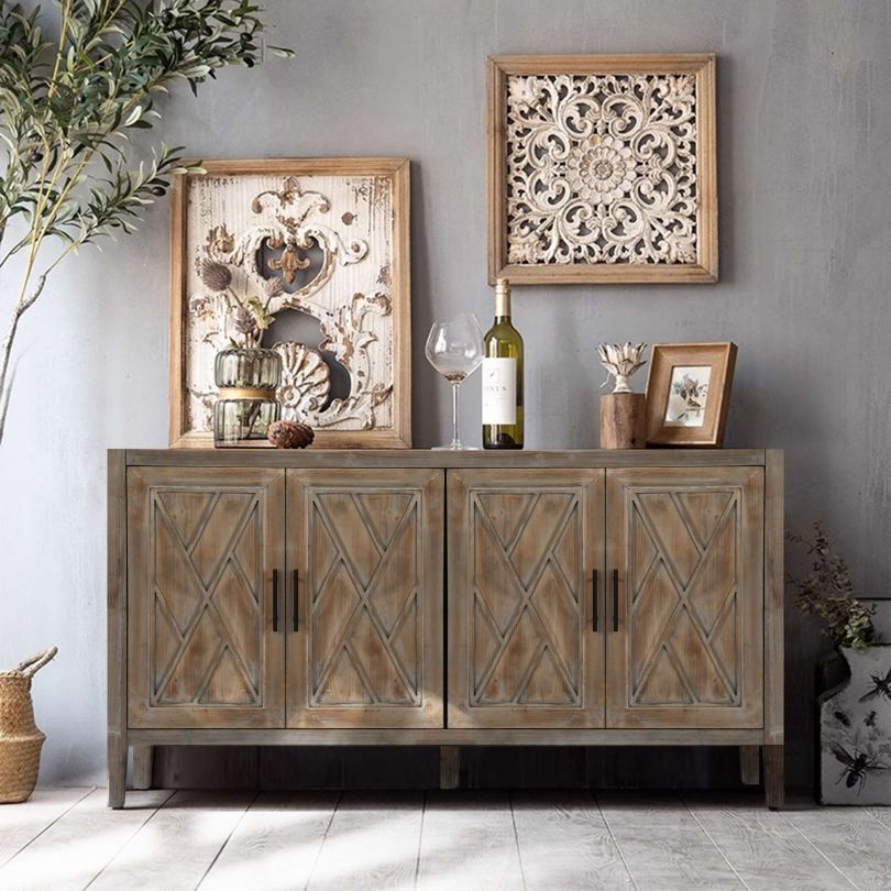 View of the antique grey wood sideboard showcasing its four doors and elegant metal handles.