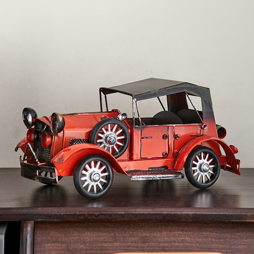 Close-up view of the antique car decor highlighting the metal craftsmanship and color palette.