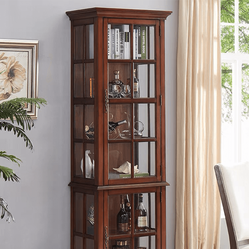 Close-up of the glass door detail on the antique wine cabinet, emphasizing craftsmanship and design.