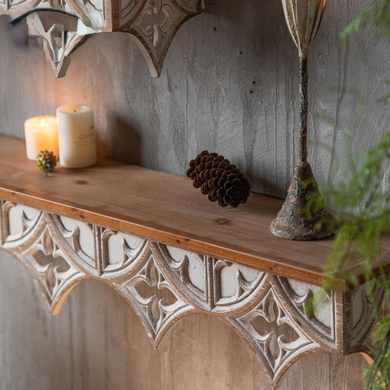 Vintage Charm Wall Shelf showcasing its hand-carved design in a cozy living room setting.