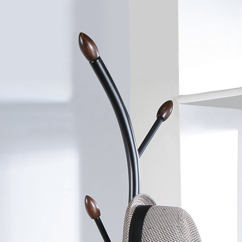 Side view of modern freestanding metal coat rack with hooks in entryway.