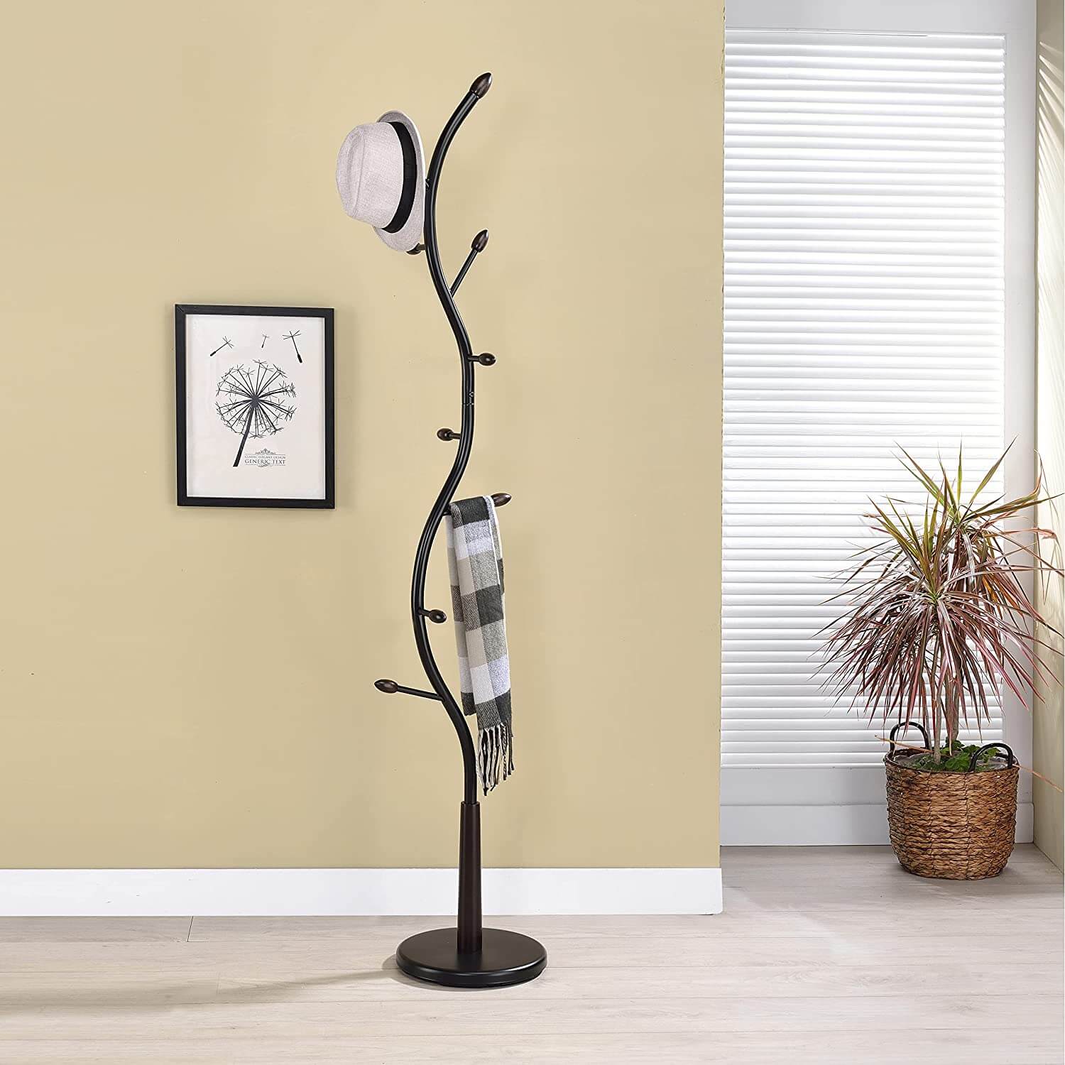 Side view of modern freestanding metal coat rack with hooks in entryway.