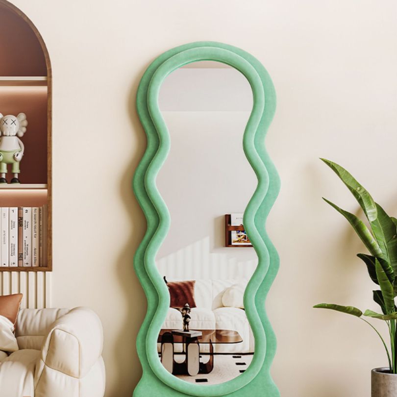 Full length mirror in a vibrant blue color, reflecting a bright and stylish bedroom interior