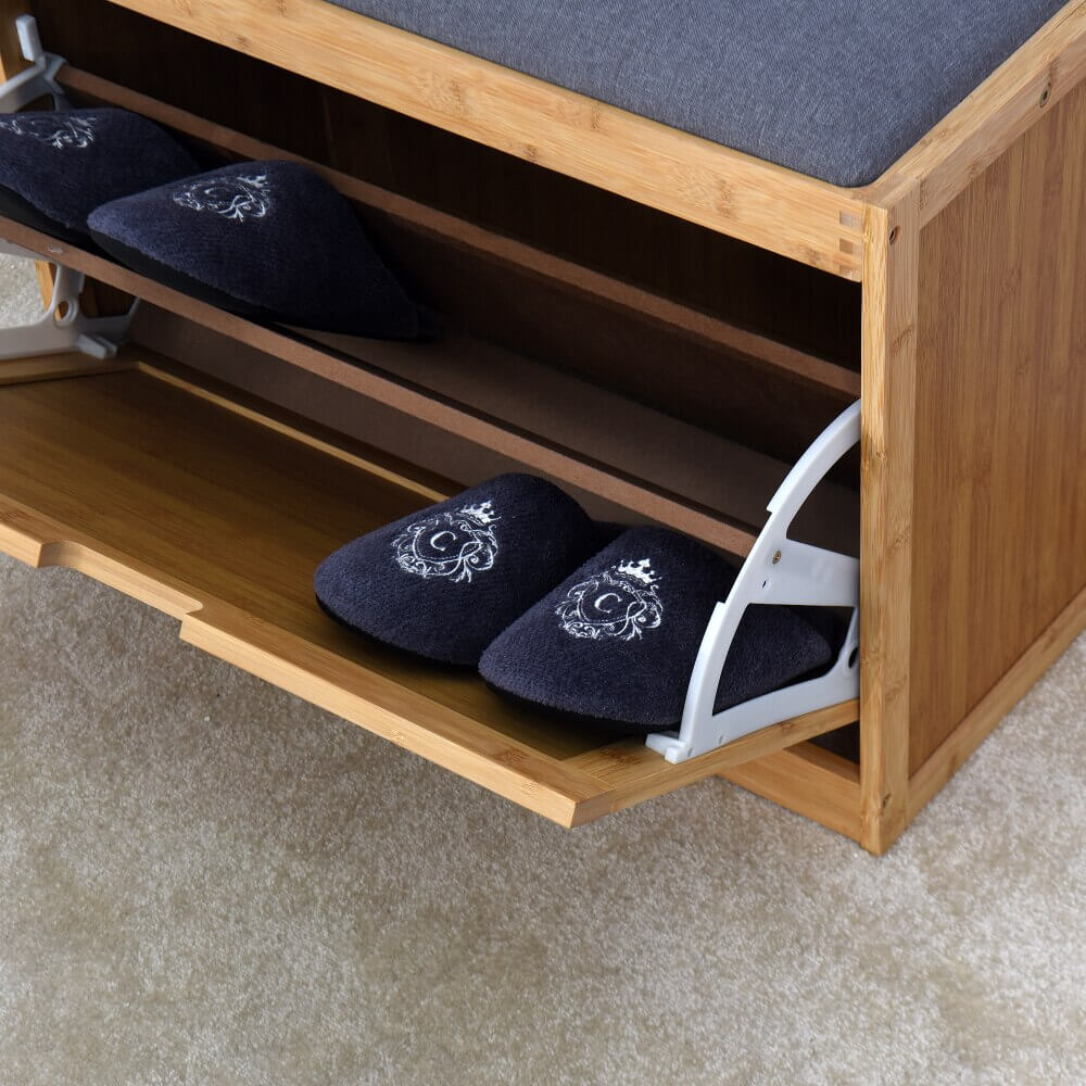 Close-up view of the flip drawer feature on the bamboo shoe bench, highlighting the storage capacity for shoes.