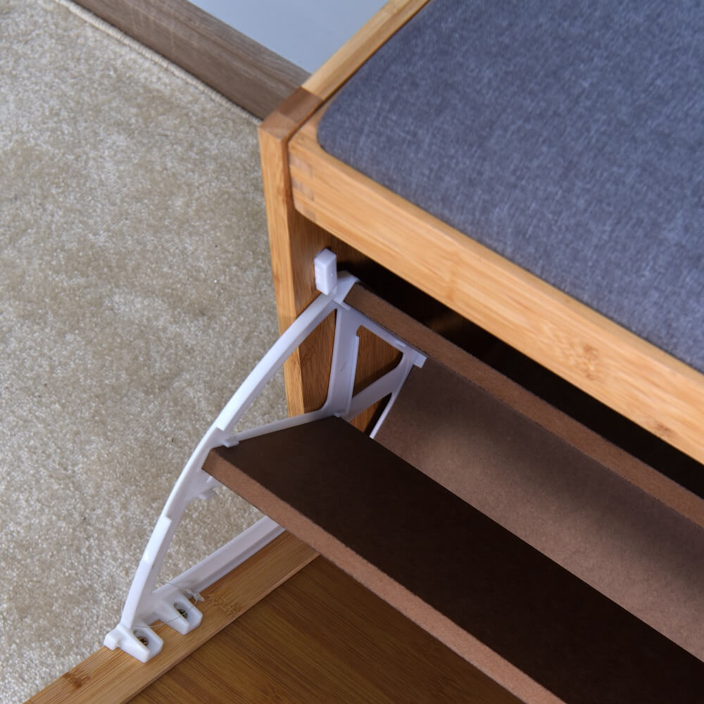 Close-up view of the flip drawer feature on the bamboo shoe bench, highlighting the storage capacity for shoes.