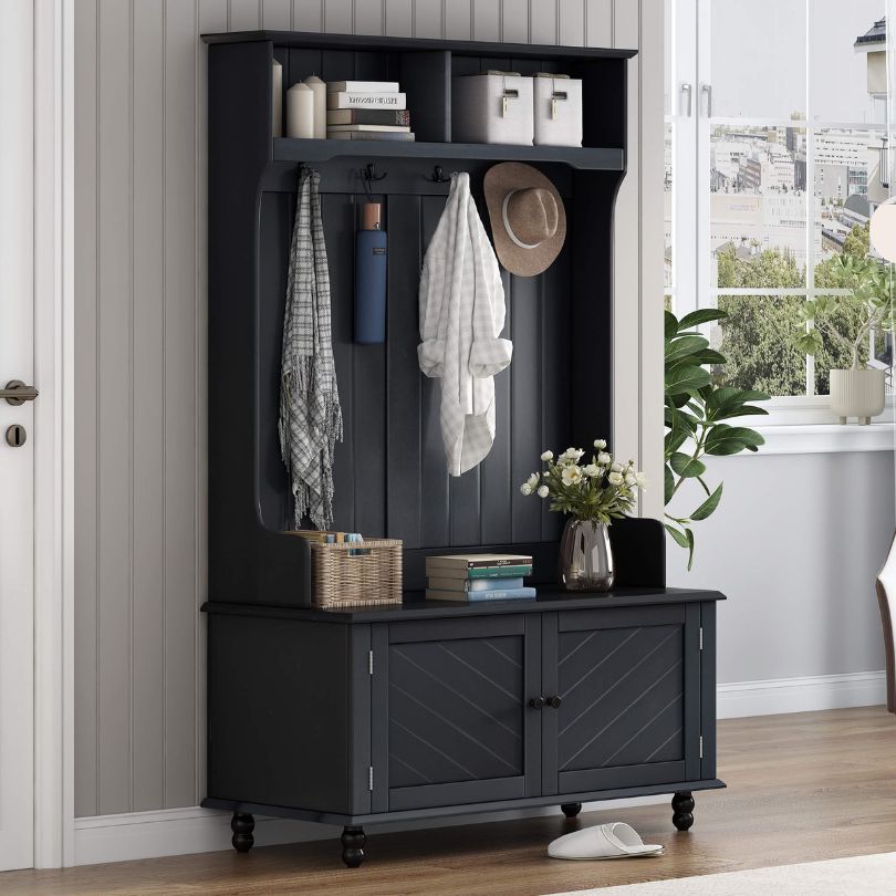 Hall tree in an entryway, featuring a bench and hooks for coats and bags.
