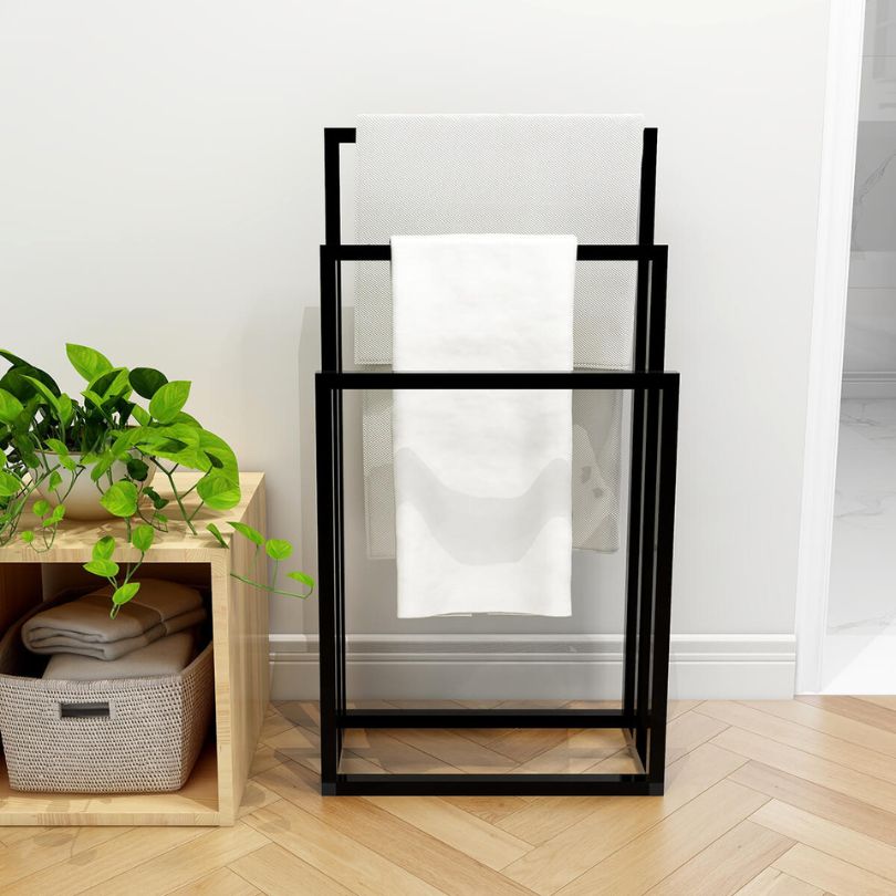 Chic black metal freestanding towel rack showing towels neatly arranged