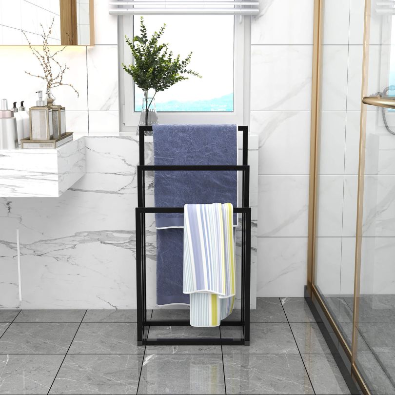 Chic black metal freestanding towel rack showing towels neatly arranged