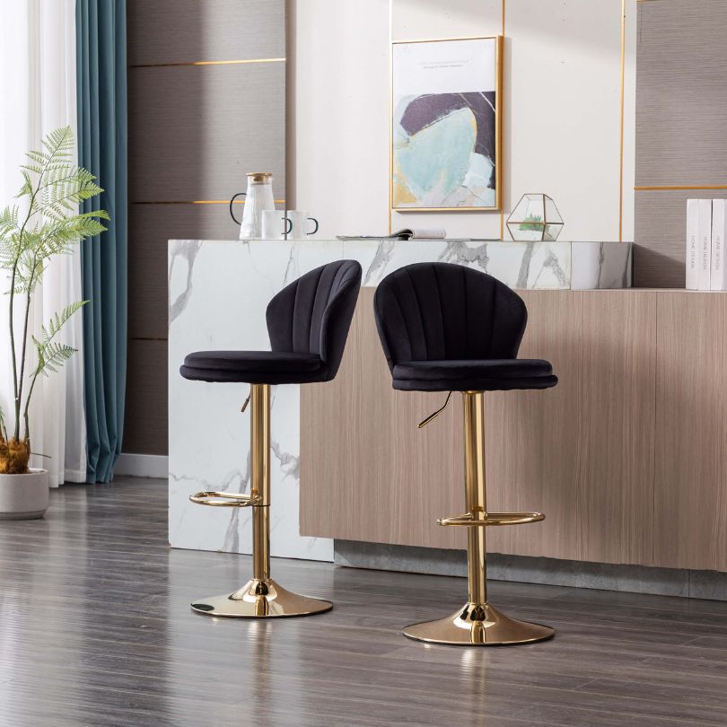 Close-up of the plush black velvet seat on the swivel stool.