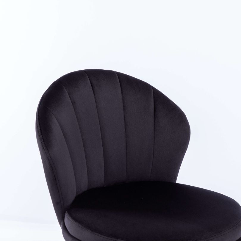 Lifestyle image of the black velvet swivel bar stool in a modern kitchen setting.