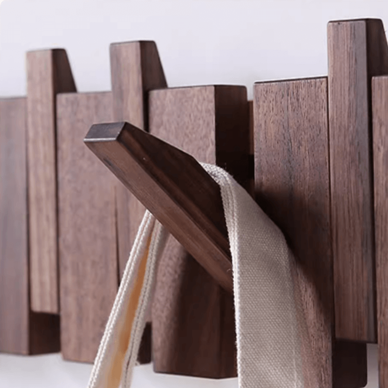 Close-up view of the modern coat rack with retractable hooks for easy storage.
