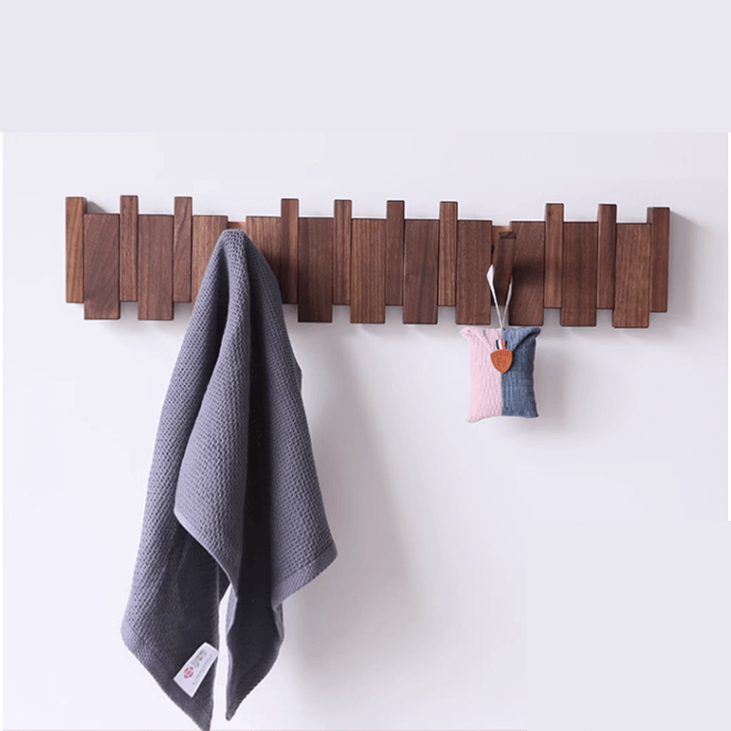 Close-up view of the modern coat rack with retractable hooks for easy storage.