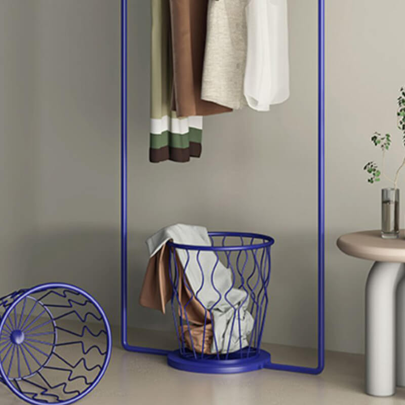 Side angle of the Sine Wave Clothes Rack demonstrating its space-saving features in a bedroom.