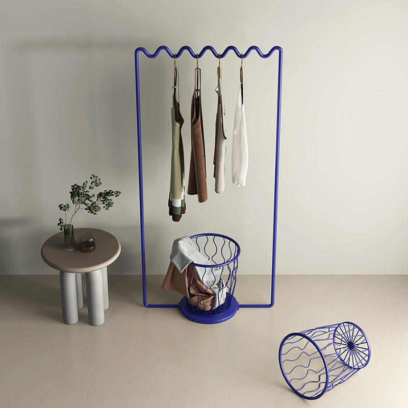Side angle of the Sine Wave Clothes Rack demonstrating its space-saving features in a bedroom.
