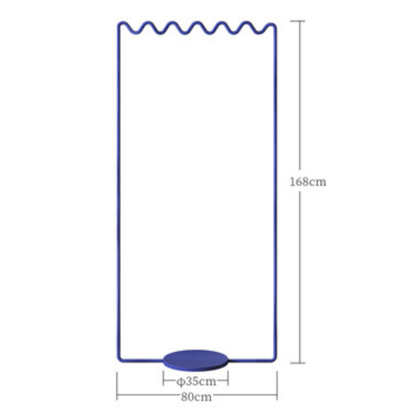 Side angle of the Sine Wave Clothes Rack demonstrating its space-saving features in a bedroom.