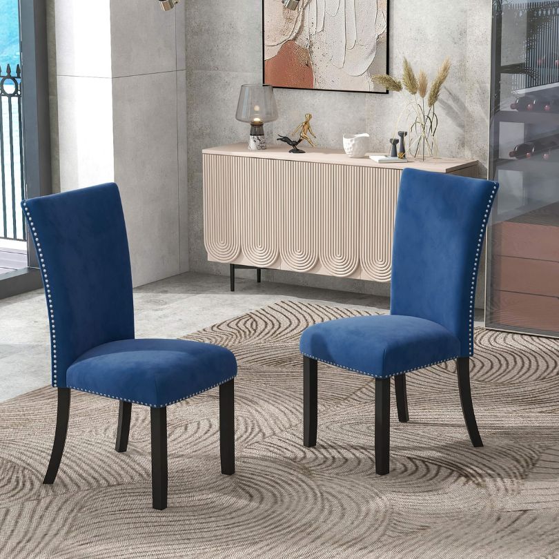 Luxurious blue velvet dining chair set on display in a contemporary dining room.