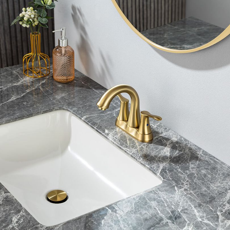 Brushed gold bathroom faucet with swivel spout from a side angle