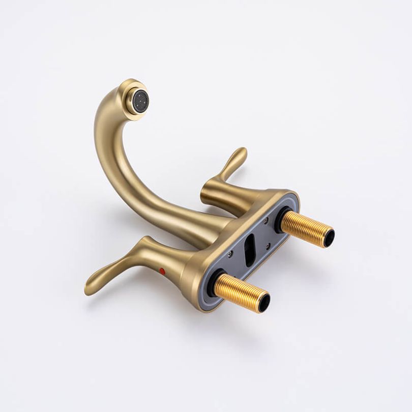 Close-up shot of the ceramic handles of the gold faucet