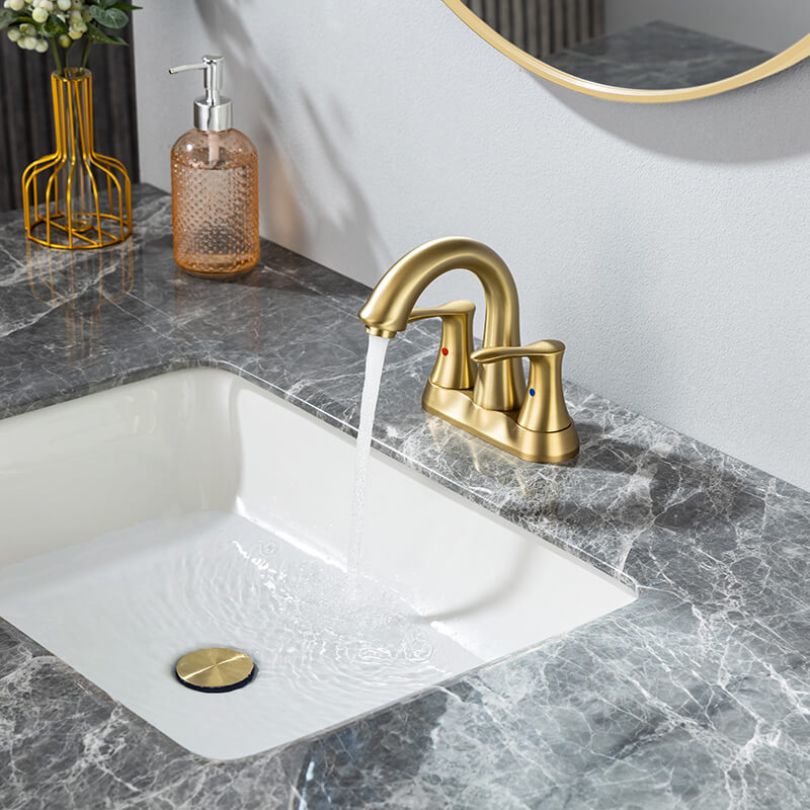 Close-up shot of the ceramic handles of the gold faucet