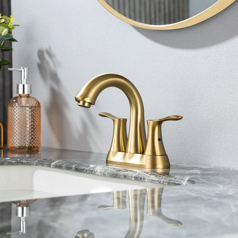 Brushed gold bathroom faucet with swivel spout from a side angle
