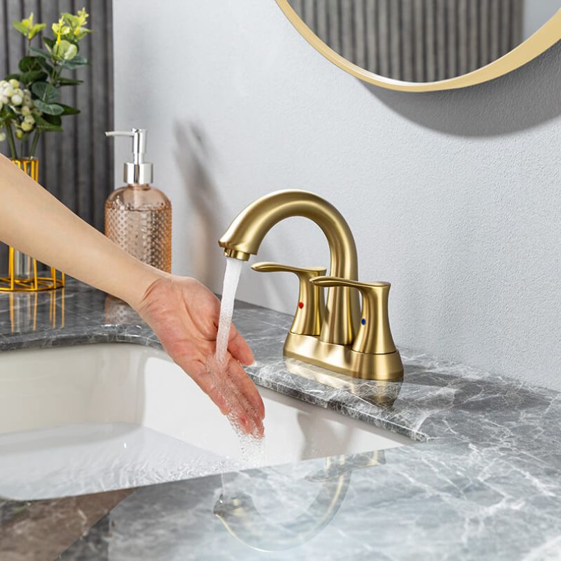 Close-up shot of the ceramic handles of the gold faucet
