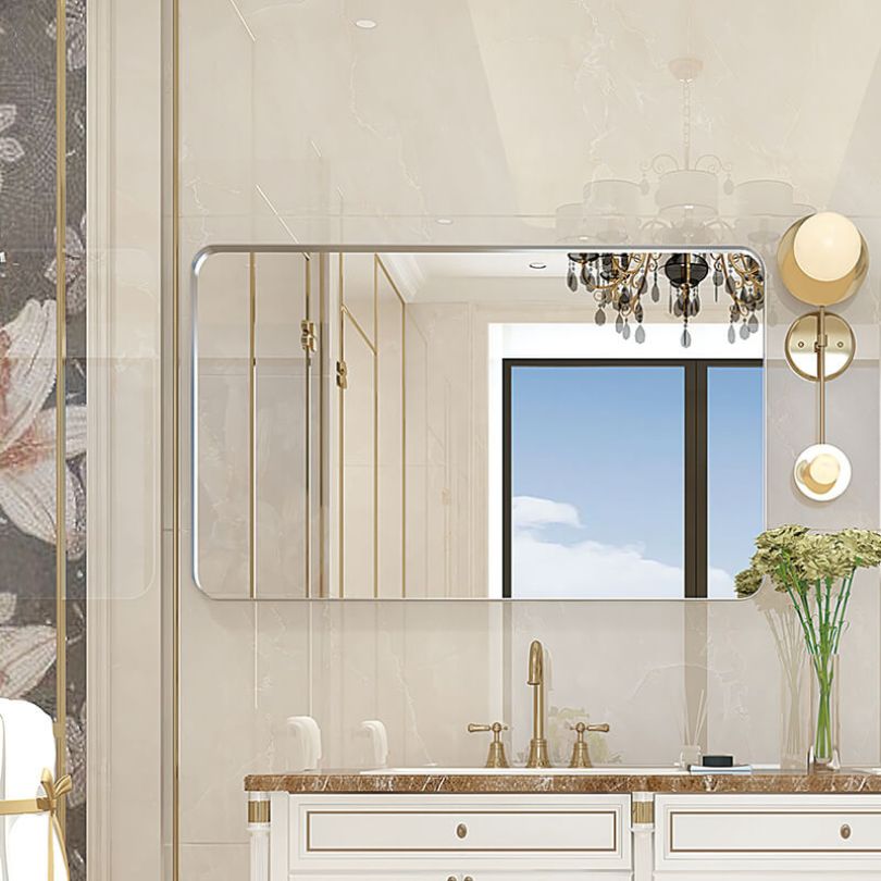A sleek 40x30 brushed silver vanity mirror mounted above a stylish bathroom sink.