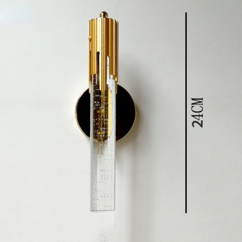 Close-up of the gold metal frame of the bubble glass wall sconce, highlighting its modern design.