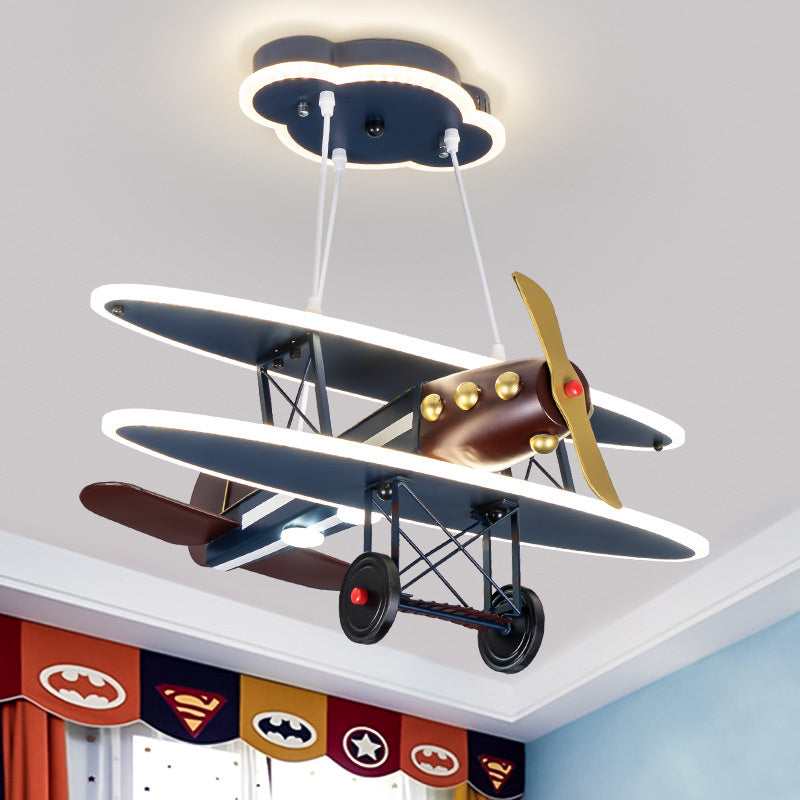 The airplane pendant light hanging above a cozy childrens study area, adding charm and creativity.