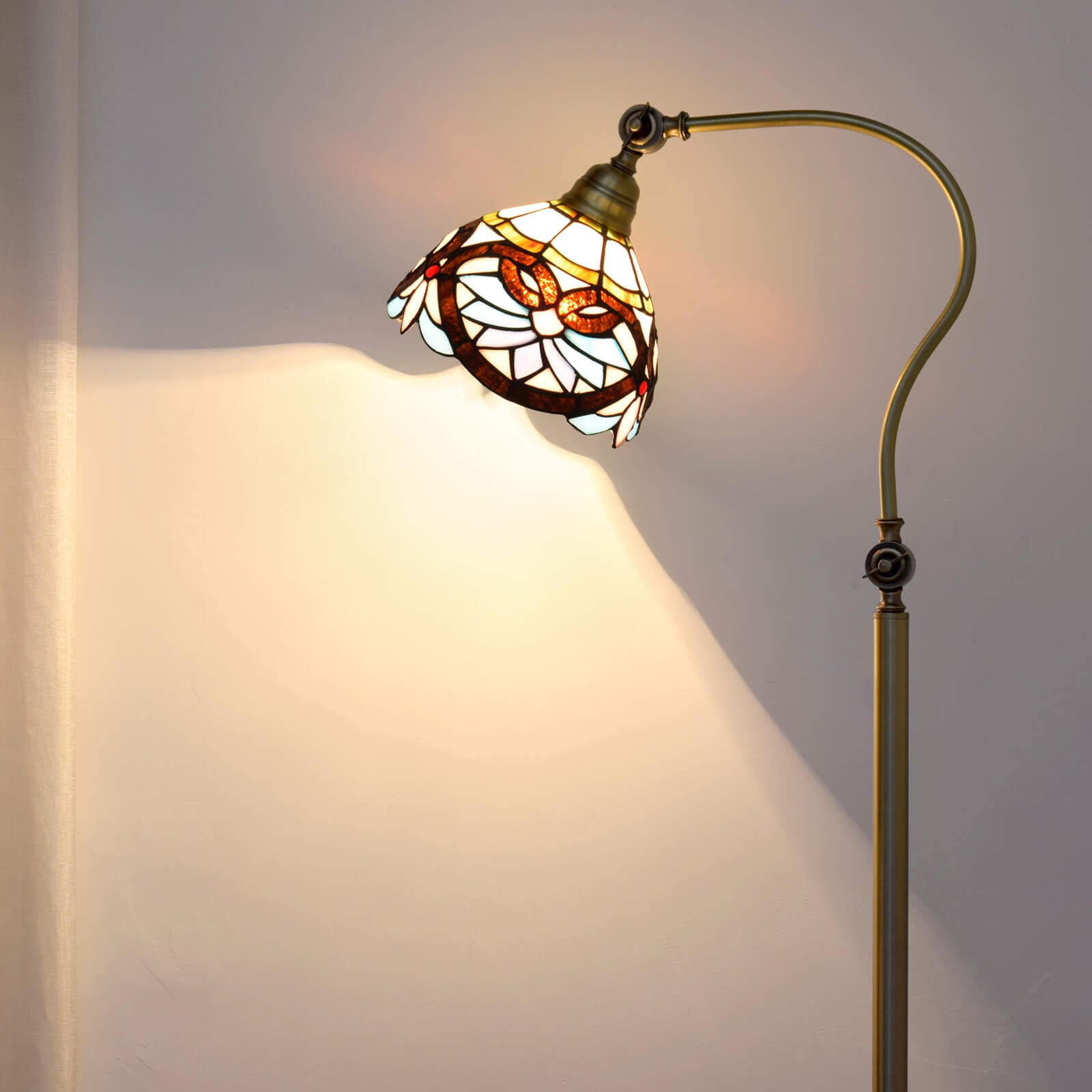 Elegant Tiffany stained glass floor lamp showcasing vibrant colors and intricate design.