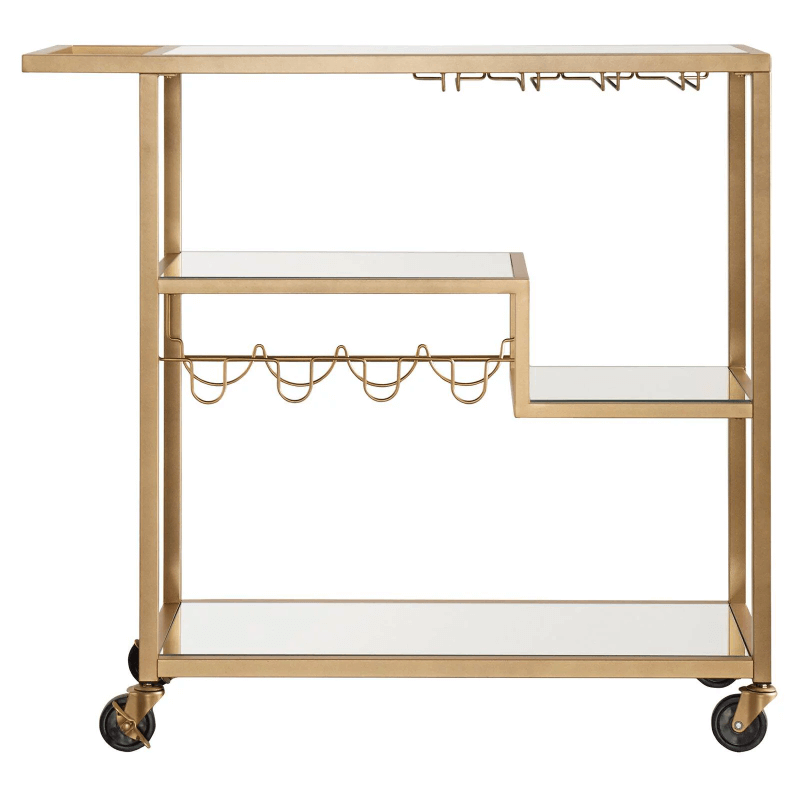Four-wheeled champagne gold mirror cart positioned next to a cozy seating area.