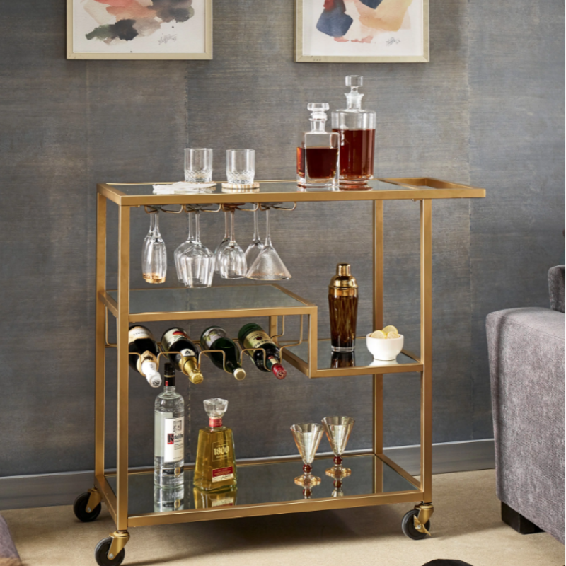 Elegant champagne gold mirror bar cart with wine rack in a stylish setting.