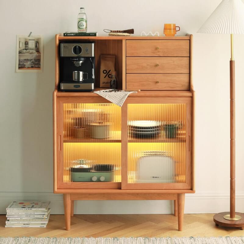 Nordic cherry wood sideboard with three drawers and sliding glass doors.