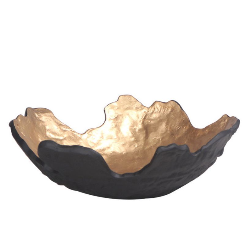 Golden fruit bowl on a kitchen counter, holding fresh fruits