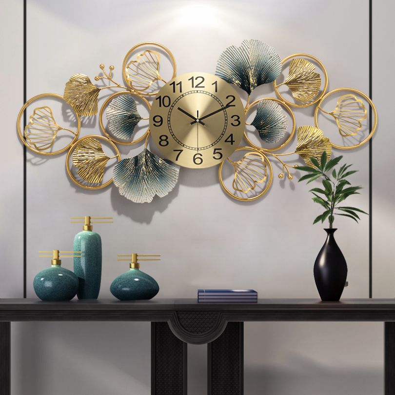 Front view of the Modern Ginkgo Leaf Design Wall Clock in a stylish living room setting.