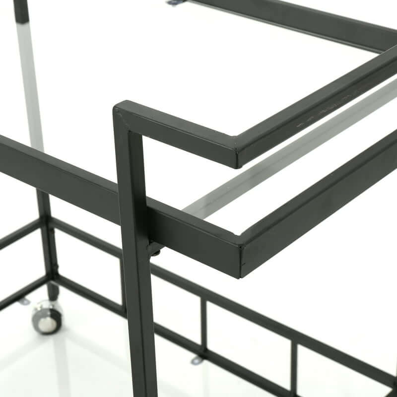 Rolling bar cart with shelves and wheels displaying a selection of cocktails in a modern kitchen.