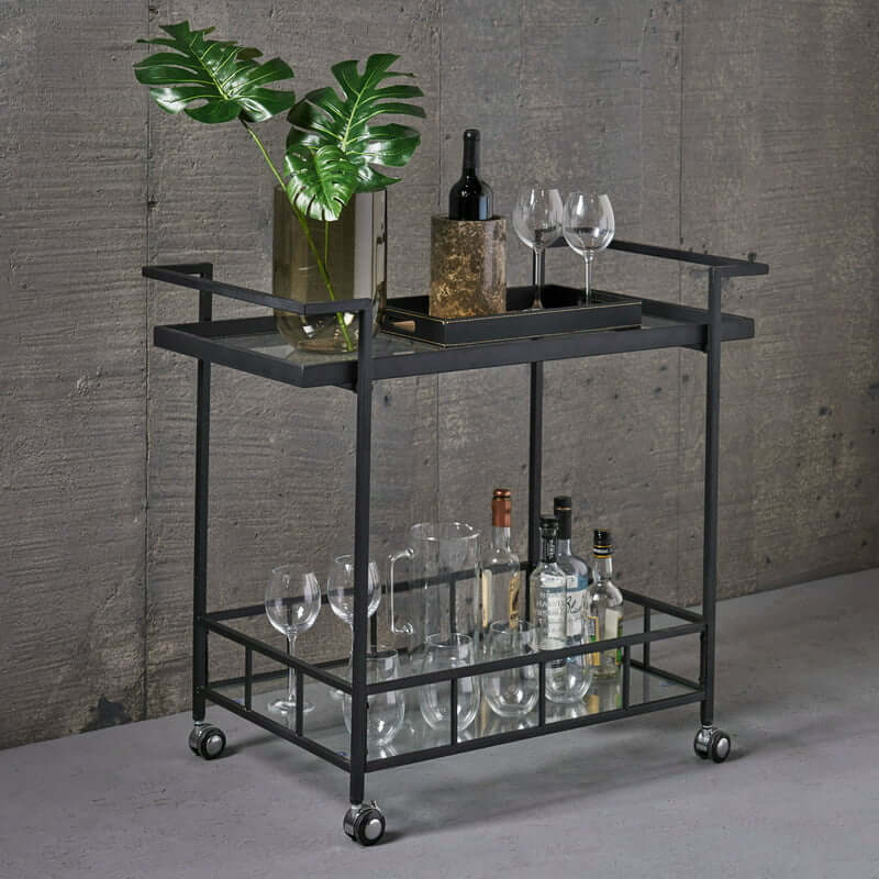 Chic black frame tempered glass bar cart showcasing wine and glasses in a dining setting.