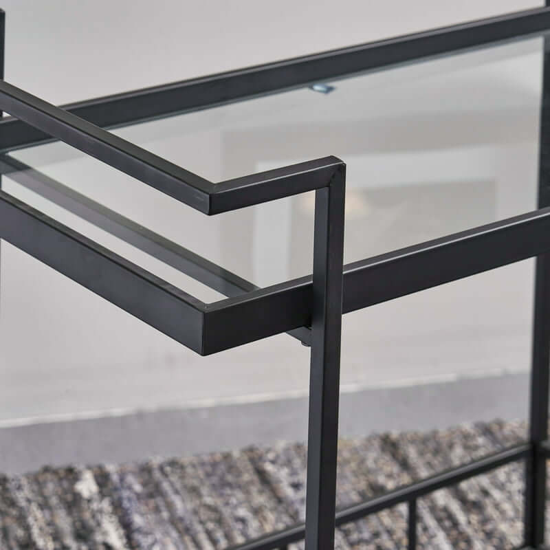 Rolling bar cart with shelves and wheels displaying a selection of cocktails in a modern kitchen.